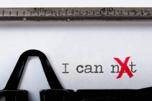 Close-up of a typewriter typing the text "I can xt" with the "x" written in red. The text implies "I can" by striking out the "not" using the red "x," signifying overcoming negativity or self-doubt, a powerful metaphor for career growth and resilience.