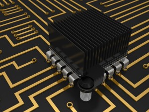 A close-up of a black heatsink positioned on a microchip with gold circuit traces resembles a well-organized resume. The black and gold color scheme highlights the intricate design of the circuit board, showcasing components that appear clean and well-structured.