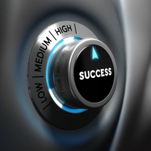 A metallic dial labeled with "LOW," "MEDIUM," and "HIGH" settings is turned to "HIGH." The center of the dial displays the word "SUCCESS" in white text on a black background. A blue glowing ring surrounds the base of the dial, indicating it is active and ready for review.