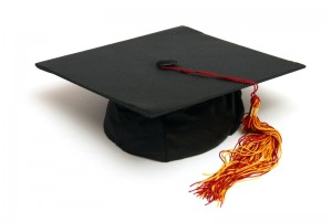 A black graduation cap with a red and gold tassel, reflecting the traditional design often seen in college ceremonies. The cap is placed on a plain white background, showcasing its timeless academic elegance.