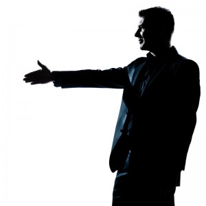 Silhouetted image of a man in a suit extending his right arm as if to shake hands, facing to the left. The background is white, enhancing the contrast and symbolizing employee engagement.