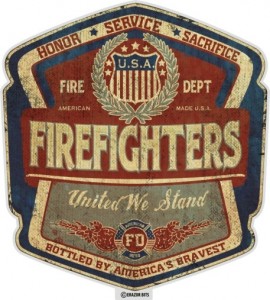 A badge-shaped emblem featuring the words "Firefighters" in large text. Above, it reads "Honor, Service, Sacrifice," and "Fire Dept, American Made, U.S.A." Below, it says "United We Stand" and "Bottled by America's Bravest" with a small Fire Service insignia.