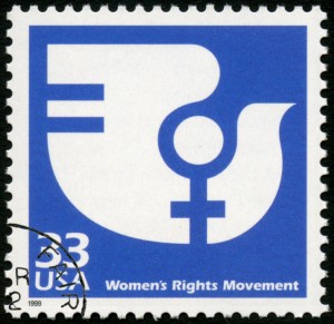 A postage stamp from 1999 featuring a blue and white design. The design incorporates a female gender symbol and an abstract bird shape, symbolizing gender equality. Text at the bottom reads "Women's Rights Movement." There is a partial postmark indicating RUZA 23.