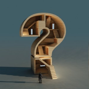 A person stands in front of a large building shaped like a question mark, symbolizing the enigmatic journey of their career. Inside, multiple staircases and doors hint at various paths one might take. The background is a muted blue, and the surreal structure casts a shadow on the ground.