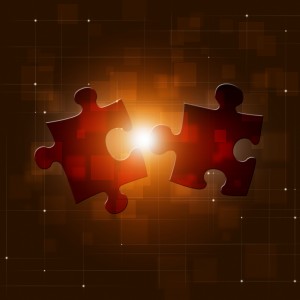 Two red jigsaw puzzle pieces are floating against a dark, abstract background with a glowing center and a grid-like pattern. The pieces are almost connected, symbolizing the support needed to complete or solve a puzzle or problem.