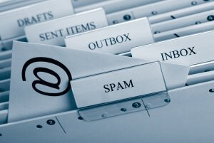 Close-up of labeled file folders in an office drawer. The visible tabs are for "Drafts," "Sent items," "Outbox," "Inbox," and "Spam." A folder with the "@" symbol is in focus, representing an email or communication-related system, much like how resume websites organize digital profiles.