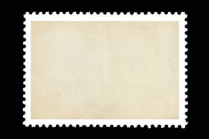 A blank, vintage postage stamp with a beige background and perforated edges is shown. The postage stamp has an aged appearance with slight discolorations and small specks, giving it an antique look.