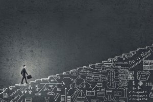 A person in business attire climbs a set of stairs, carrying a briefcase. The stairs, filled with various business-related doodles and diagrams, symbolize the complex plans and strategies essential to a successful career. The background is dark and has a textured surface.