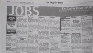 A newspaper job listings section with various employment opportunities awaits job hunters. The top of the page reads "JOBS" in bold, featuring categorized ads for positions in education, IT, medical, sales, administration, and more.