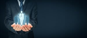 A person in a suit holds a glowing holographic figure of a boss, symbolizing leadership and management, against a dark background. Other blurred holographic figures are visible in the background.