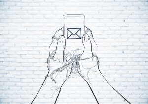 An artistic line drawing depicts two hands holding a smartphone with an envelope icon on the screen, symbolizing a new email. The background is a white brick wall, providing a textured contrast to the minimalist sketch.
