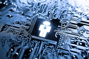 A close-up image of a computer motherboard with intricate circuitry. At the center, a glowing icon of a person wearing a tie is embedded into the circuit, symbolizing HR Trends and human integration with technology. The overall hue is blue, emphasizing a high-tech feel.