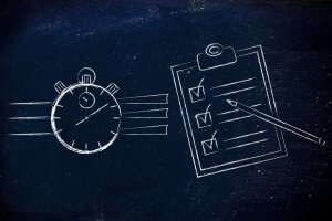 A chalk drawing on a dark background shows a stopwatch on the left and a clipboard with a checklist and pencil on the right. The stopwatch and checklist symbolize efficient time management and successful task completion.