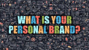 Image with a background covered in various colorful, hand-drawn icons related to technology and communication. Bold, multi-colored text in the center asks, "WHAT IS YOUR PERSONAL BRAND?" in a mix of blue, green, red, orange, and yellow letters. Remember: body language speaks volumes!