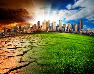 A city skyline is depicted under a split sky, showing environmental contrast and cultural reflections. The left side shows a dry, cracked land with a smoky, brown sky, symbolizing pollution and climate change. The right side shows lush green grass under a blue sky with white clouds, representing a healthy environment.