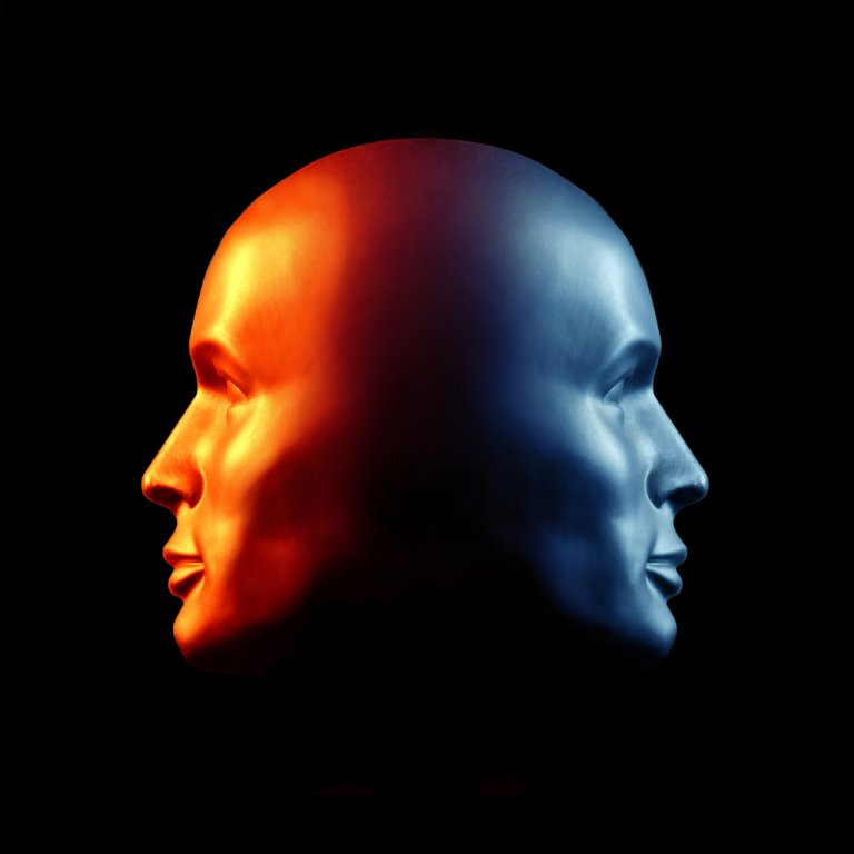 A 3D illustration of a human head with two faces, one looking left and the other right. The left side is illuminated with warm, orange light and the right side with cool, blue light, creating a striking contrast against a black background, highlighting the authenticity of dual perspectives.