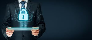 A person in a suit holds a tablet, from which a glowing lock icon connected by digital lines emerges, symbolizing cybersecurity and data protection. The dark background emphasizes the lock icon, underlining the concept of technological security.