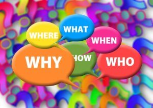 Colorful background with multicolored speech bubbles containing the words "WHY," "WHERE," "WHAT," "WHEN," "WHO," and "HOW" in white text, representing common question words that a dispatcher might encounter. The background features abstract, multicolored shapes.