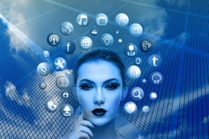 A woman's face, tinted blue and with a thoughtful expression, is seen overlaid on a background of a glass-panel building that reflects the sky. Surrounding her head are various social media and communication icons, including Facebook, Twitter, LinkedIn, and email.