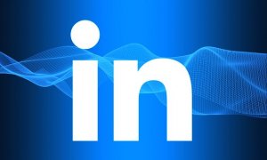 Blue background with a digital wave pattern and the white LinkedIn logo. The logo consists of the letters "in," with the "i" in lowercase and a dot above it, signifying the professional networking website, LinkedIn.