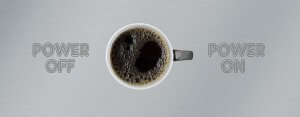 A cup of black coffee viewed from above is centered between the words "Power Off" on the left and "Power On" on the right, set against a metallic background, symbolizing a balance between energy and rest.