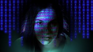 A woman's face is partially visible in a dark setting, with blue binary code (0s and 1s) projected onto her, creating a pattern of digits across her face and the background. The atmosphere evokes themes of technology or cybersecurity, much like a digital rolodex cataloging endless data.