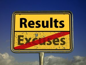A yellow road sign stands against a backdrop of a blue sky with wisps of white clouds. Boldly labeled "Results," with "Excuses" crossed out below in red lines, it offers clarity amidst chaos.
