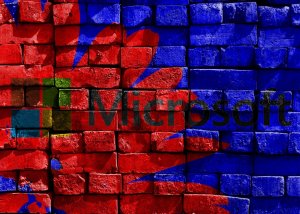 A brick wall painted with a colorful design featuring the Microsoft logo. The background consists of red and blue abstract shapes intersecting with the logo, prominently displayed in the center, celebrating creativity and productivity inspired by Office 365.