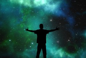 A silhouette of a person standing with arms outstretched against a vibrant, star-filled galaxy background, with shades of green, blue, and black resembling a nebula. The scene evokes a sense of wonder and the vastness of the universe, as infinite as the challenges faced by government explorers.