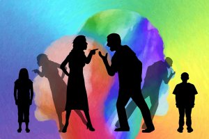 Silhouettes of a woman and a man arguing with their fingers pointed at each other. A child stands to the left of the woman and to the right of the man, while colorful, abstract shapes form the background. Another shadowed figure mirrors the arguing couple's actions, highlighting a need for mental fitness.