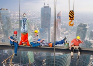 Five construction workers parody the famous "Lunch atop a Skyscraper" photo, sitting and hanging precariously from a steel beam high above a city skyline. With two hanging upside down and others resting casually, this playful twist embodies a culture change in how we view iconic scenes.