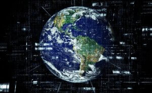 A digital representation of Earth against a dark background filled with lines of code and data streams. The continents are clearly visible with vibrant colors, while the surrounding space is filled with abstract, technological elements suggesting a global digital network, highlighting the vast realm of IT jobs.