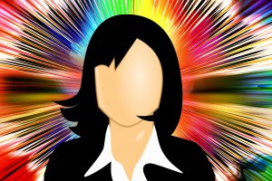 Graphic of a faceless person with shoulder-length black hair, wearing a white collared shirt and black jacket. Background features a burst of vibrant, radiating colors—red, yellow, green, and blue—creating an energetic and dynamic effect that symbolizes core values.