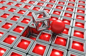 A 3D illustration depicting a patterned surface with shiny metallic square frames. Each frame holds a glossy red sphere, except for two empty squares in the middle. These feature a hollow metallic cube and a lone red sphere on top, illustrating the inherent decisions within design.