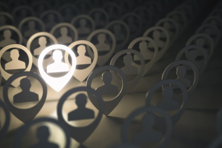 A glowing user icon within a pin shape stands out among rows of dark, identical user icons in pin shapes. The icons are arranged in a repetitive pattern, symbolizing the concept of highlighting or selecting an individual from a group during the unprecedented times of COVID-19 employment challenges.