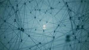 A networking diagram featuring interconnected nodes on a blue background, with lines representing connections between them. Among the nodes, one is depicted as a person icon and is highlighted, suggesting focus or importance.