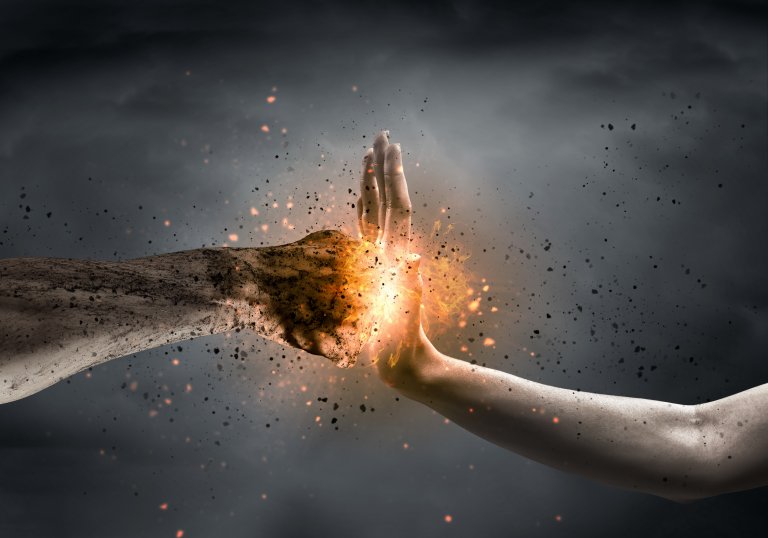 A dramatic image depicting two hands, one covered in dark soot and the other in clean white, colliding defensively amidst sparks and flames, creating an intense and powerful visual impact against a dark, smoky background.