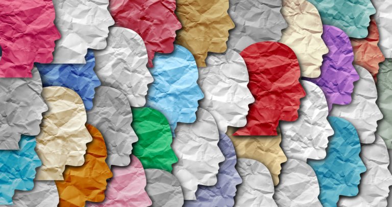 Crumpled paper cutouts of human profiles in various colors are arranged in a dense, overlapping pattern. The vibrant hues and textured surfaces create a visually dynamic collage, symbolizing diversity and individuality—much like careers in government that bring varied talents together to serve the public.