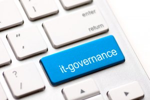 A close-up of a computer keyboard highlights a blue key labeled "it-governance" replacing the usual "Enter" key, surrounded by standard white keys. This unique setup resonates with those exploring careers in government and underscores the importance of IT skills in modern Gov Jobs.
