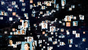 A digital collage featuring numerous small, square photos of diverse individuals. The photos are interconnected by lines and nodes, creating a web-like network reminiscent of LinkedIn against a dark background with abstract data patterns, symbolizing a connected global community.