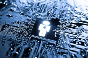 An abstract image depicting a person icon wearing a suit and tie, illuminated in blue, stands at the center of a network of circuit board pathways. The intricate circuitry symbolizes the connectivity and technology surrounding the human figure, representing HR integration within tech systems.