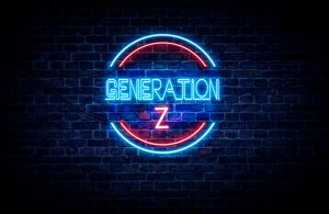 A neon sign on a brick wall reads "Gen Z" with "Gen" in blue and "Z" in red. A red circular outline surrounds the text, creating a vibrant, glowing effect against the dark background.