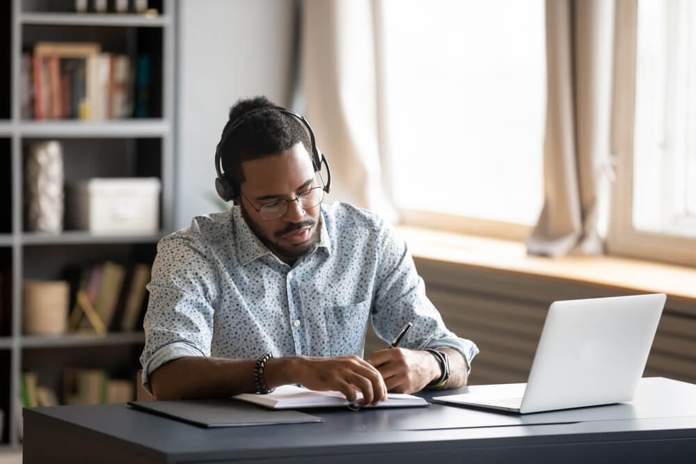 Concentrated,Millennial,African,American,Guy,Wearing,Earphones,,Listening,To,Favorite video presentation