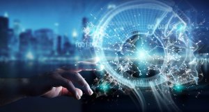A hand reaches out to touch a digital representation of a human head made up of interconnected lines, dots, and circuitry, symbolizing artificial intelligence and technology. In the blurred background, a cityscape with tall buildings hints at government infrastructure shaping our future.