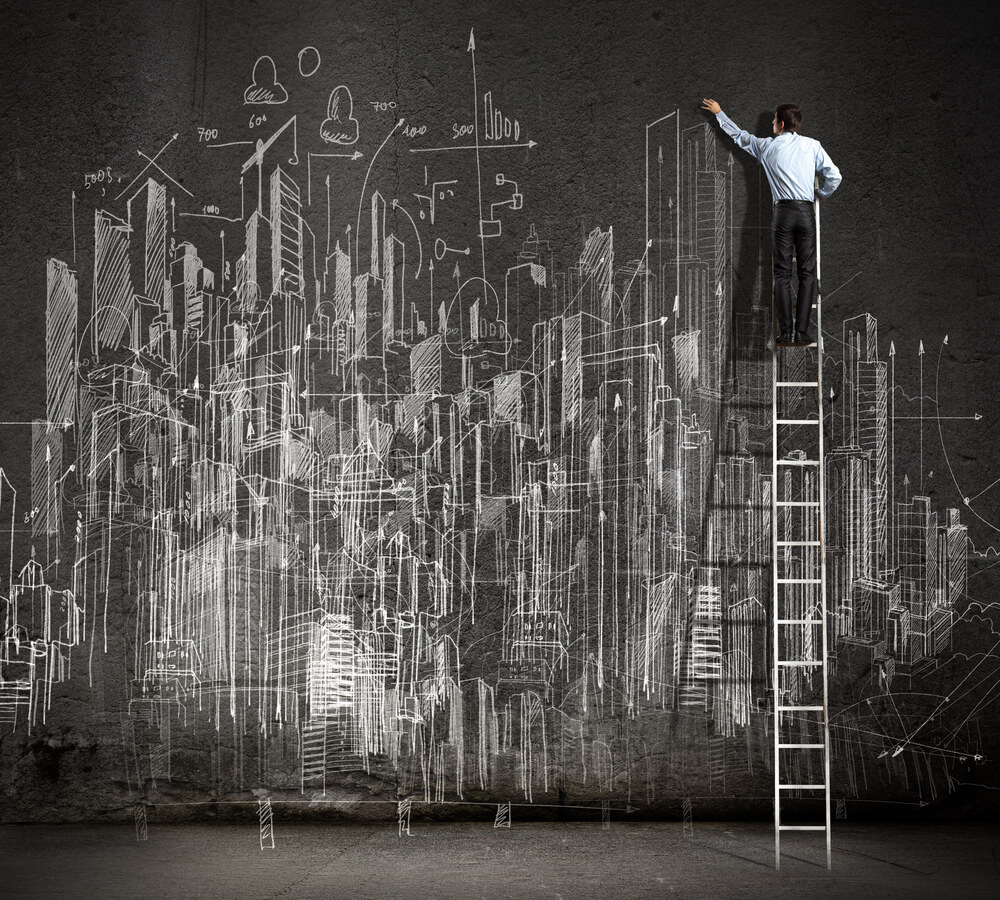 Rear,View,Of,Businessman,Standing,On,Ladder,And,Drawing,Business women's leadership