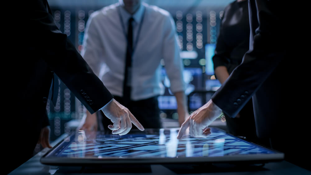 Corporate,Managers,Working,At,The,Table,In,Monitoring,Room.,Room