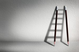 Two pencils forming a shadow that looks like a ladder