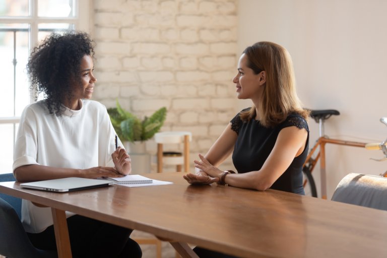 Two women sitting and having a discussion