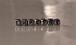 Metal dice forming a word ‘Empathy’