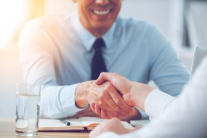 A close up of two men shaking hands